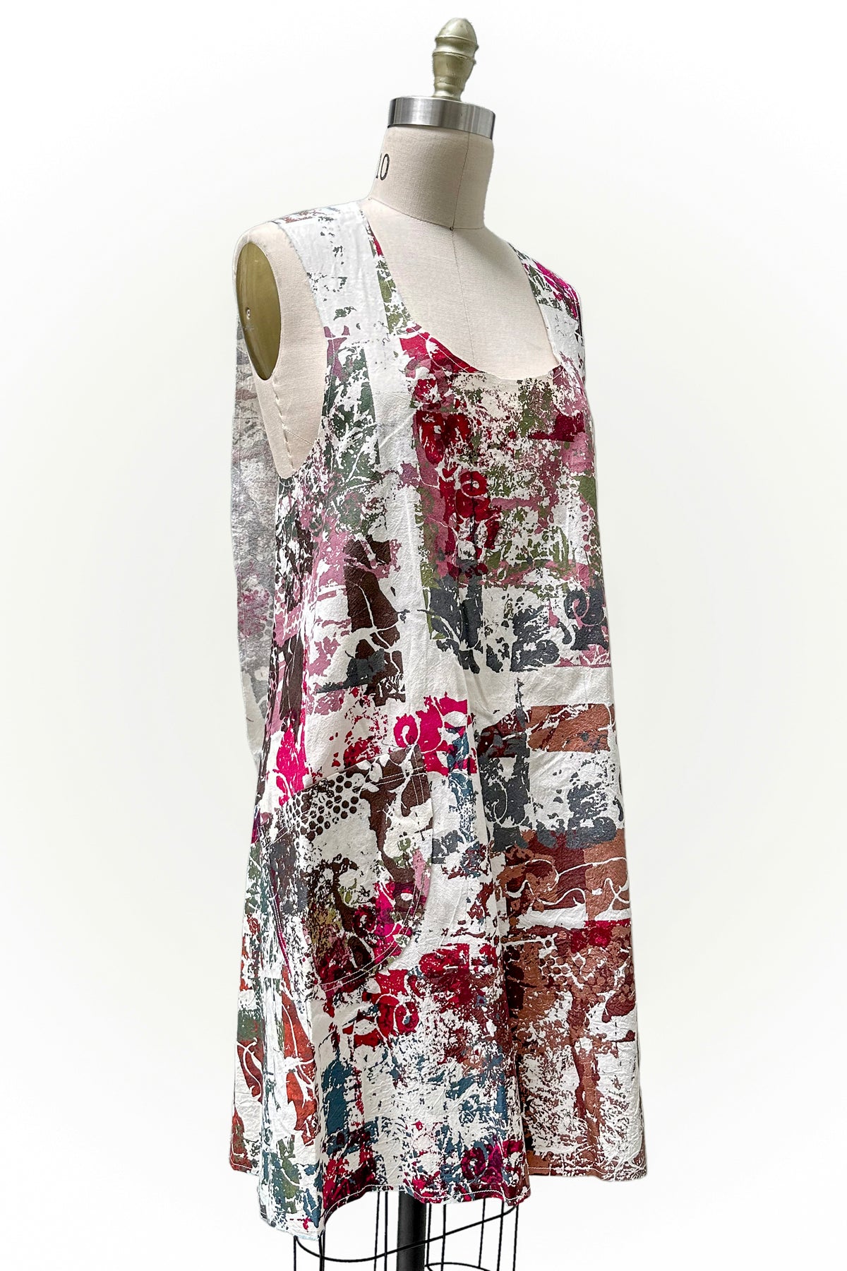 Handcrafted apron dress with crisscross back, functional front pockets, practical silhouette, and an adjustable open design for comfort and movement.